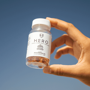 someone holding hero cbd capsules