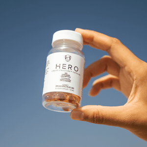 
            
                Load image into Gallery viewer, someone holding hero cbd capsules
            
        